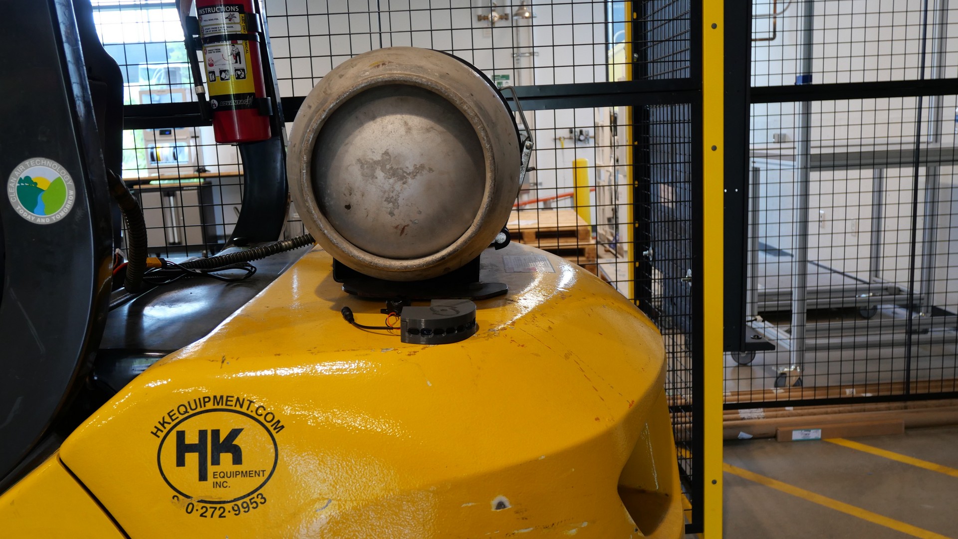 Compact proximity sensor mounted on the rear body of a yellow forklift